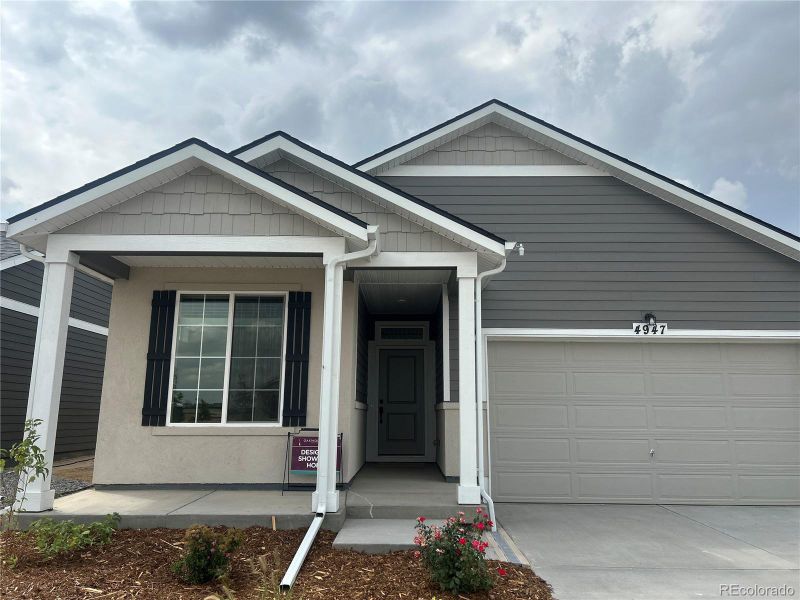 Front exterior of a new home in The Reserve, Aurora, CO, highlighting curb appeal (Image 1). Front exterior of a new home in The Reserve, Aurora, CO, highlighting curb appeal (Image 1).