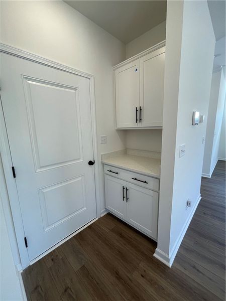 This interior hallway features crisp cabinetry, st