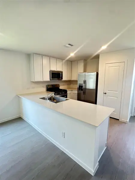 Furnished interior view inside a new home in Binford Creek: Cottage Collection, Waller (Image 6).