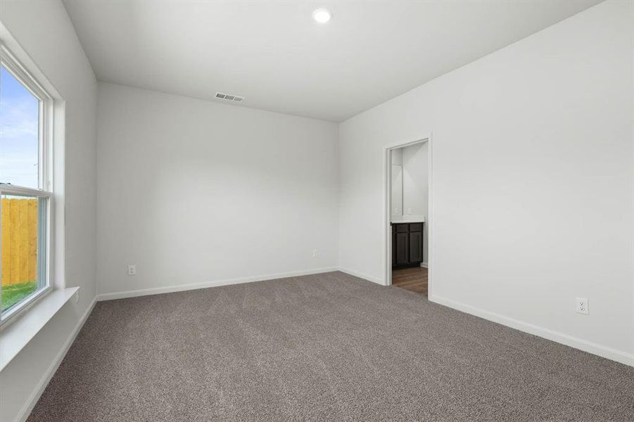 Carpeted spare room with baseboards