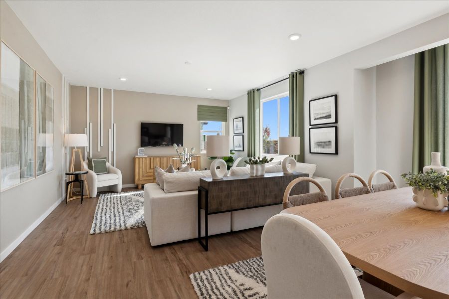 A large living room with a large table and chairs. A large living room with a large table and chairs.