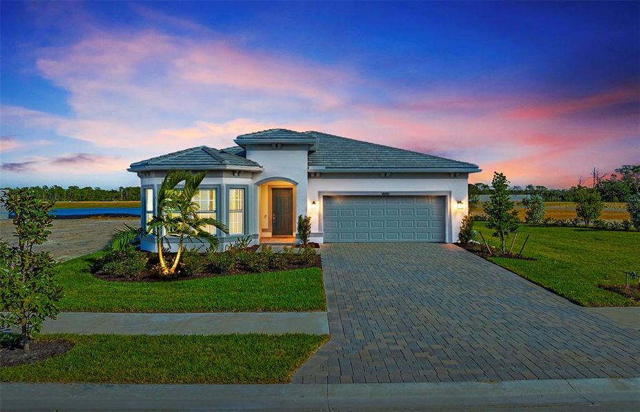 Front exterior of a new home in Shores at Stillwater, Englewood, FL, highlighting curb appeal (Image 22).