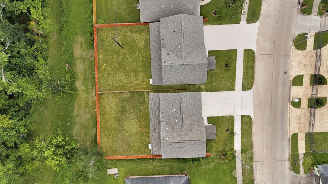 Full lot view highlighting driveway, yard, and home footprint. Full lot view highlighting driveway, yard, and home footprint.