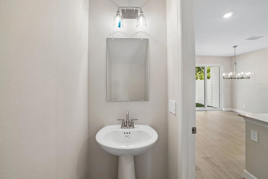 Half bathroom located off the kitchen