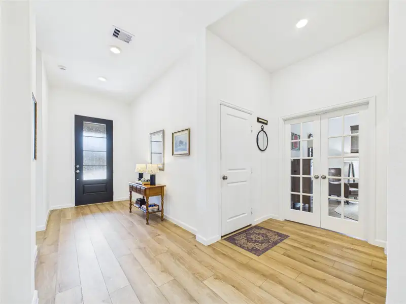 Back at the front of the home down a small hallway is the garage, office and half bathroom.