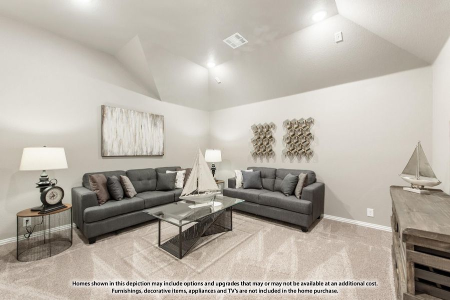 Living room with vaulted ceiling, two gray sofas, glass coffee table, and carpet flooring Living room with vaulted ceiling, two gray sofas, glass coffee table, and carpet flooring