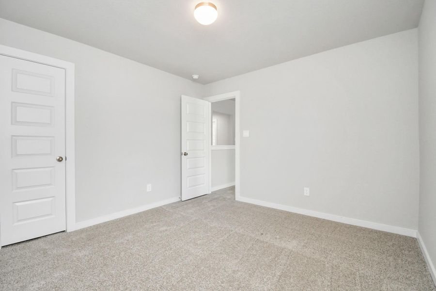 Generously sized secondary bedrooms featuring spacious closets, soft and inviting carpeting underfoot, large windows allowing plenty of natural light, and the added touch of privacy blinds for your personal retreat.