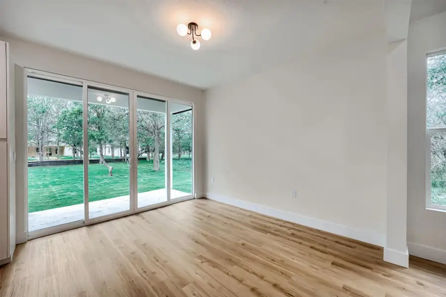 Bright dining area with large sliding glass doors overlooking the backyard