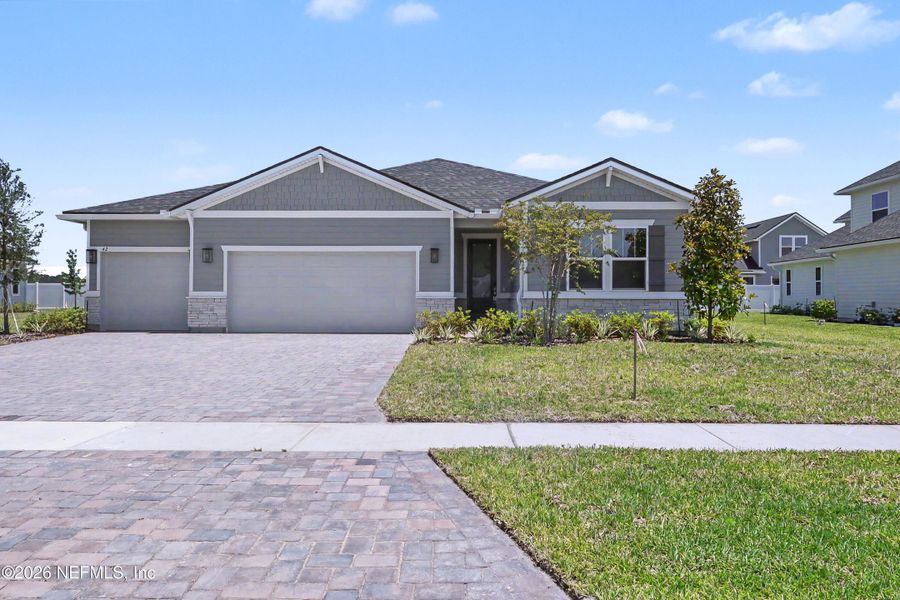 Front exterior of a new home in Brookestone, St. Augustine, FL, highlighting curb appeal (Image 2). Front exterior of a new home in Brookestone, St. Augustine, FL, highlighting curb appeal (Image 2).
