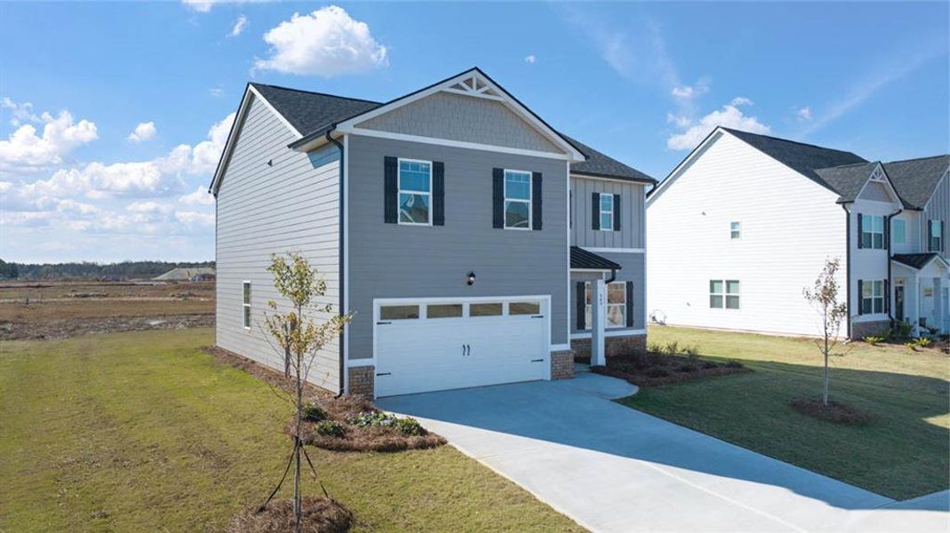Front exterior of a new home in Champion's Run, Lithonia, GA, highlighting curb appeal (Image 17).