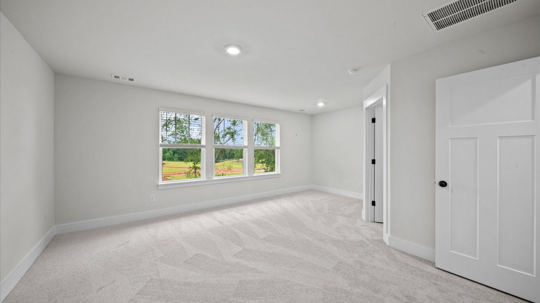 Expansive primary suite with large windows in two story townhome at Ransdell Pointe by DRB Homes in Spartanburg, SC Expansive primary suite with large windows in two story townhome at Ransdell Pointe by DRB Homes in Spartanburg, SC