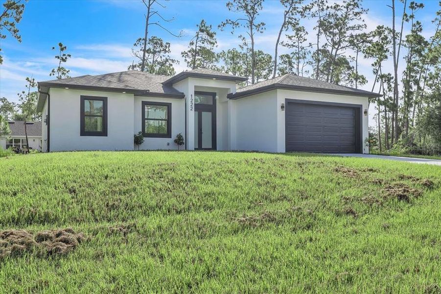 Front exterior of a new home in , Port Charlotte, FL, highlighting curb appeal (Image 2). Front exterior of a new home in , Port Charlotte, FL, highlighting curb appeal (Image 2).