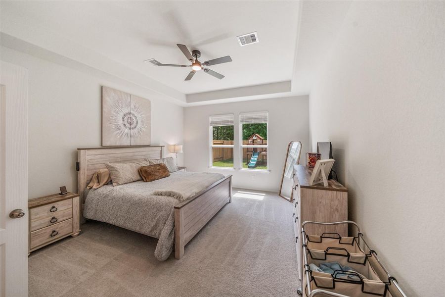 Spacious primary bedroom on first floor also has a nice view of the backyard