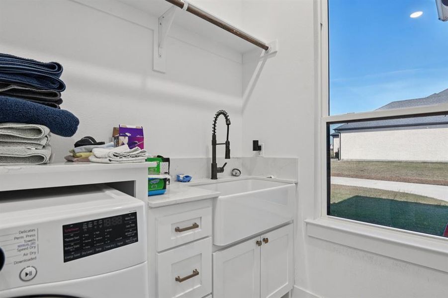 Laundry room with washer / clothes dryer and cabinet space Laundry room with washer / clothes dryer and cabinet space