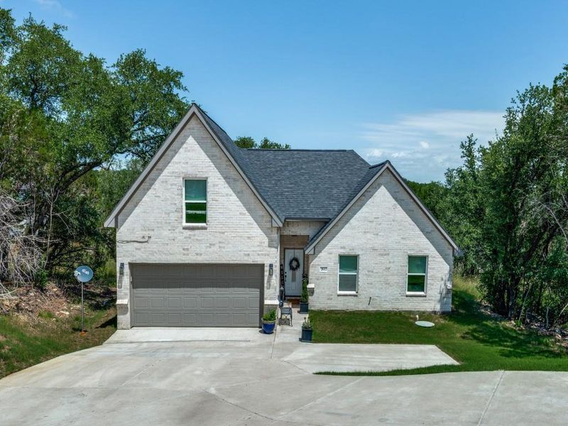 View of front of house with an attached garage, concrete driveway, a front yard, and roof with shingles View of front of house with an attached garage, concrete driveway, a front yard, and roof with shingles