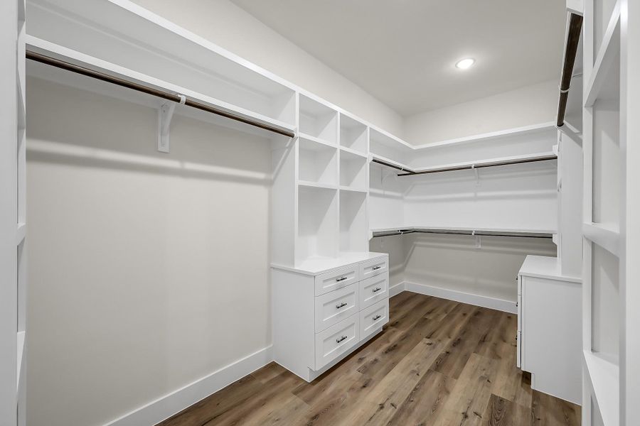 The large owner’s retreat walk-in closet features plenty of built-in storage.