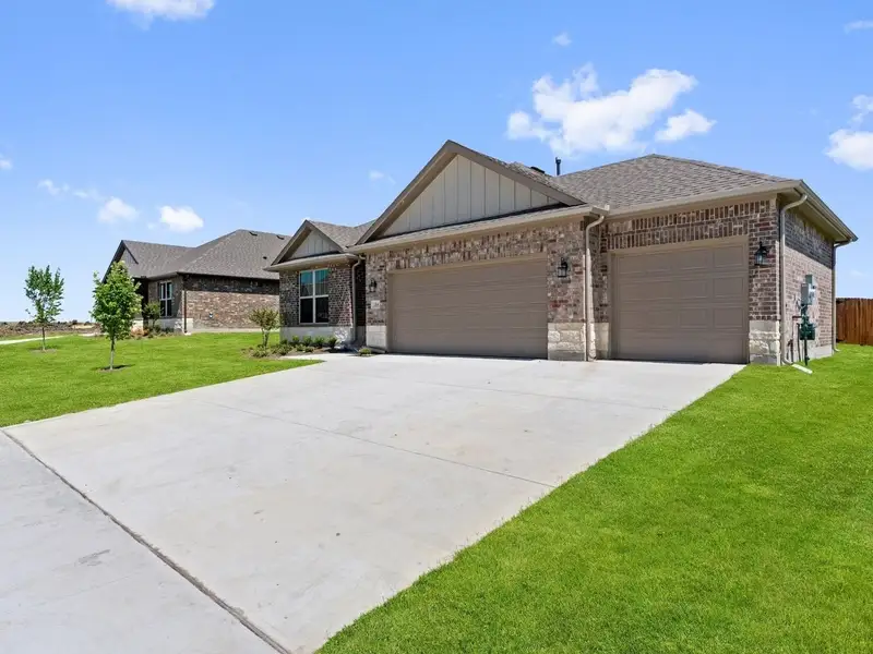 Front exterior of a new home in Waverly Estates, Nevada, TX, highlighting curb appeal (Image 1). Front exterior of a new home in Waverly Estates, Nevada, TX, highlighting curb appeal (Image 1).