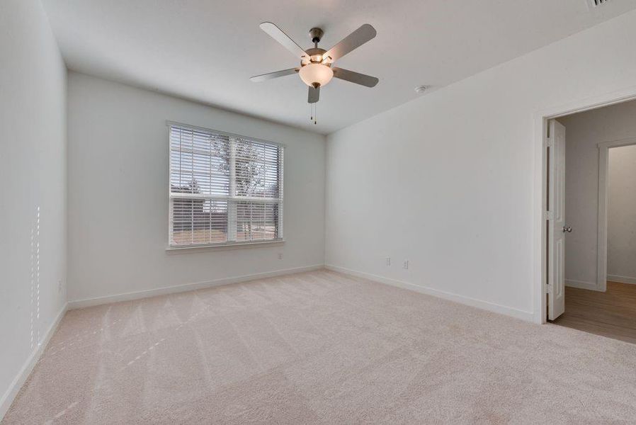 Spare room featuring carpet floors and ceiling fan Spare room featuring carpet floors and ceiling fan