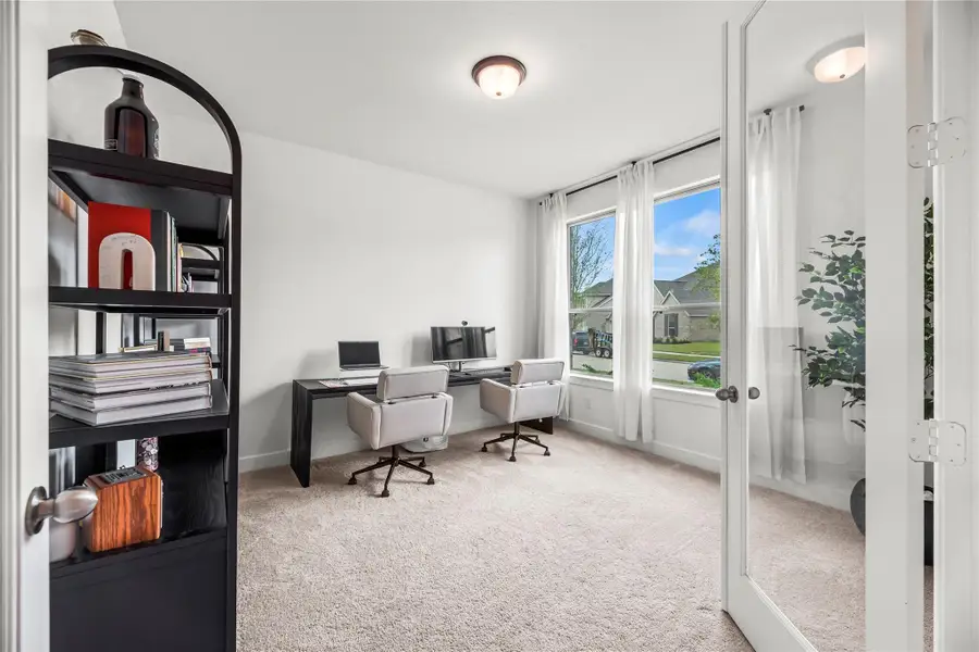 You’re going to love the morning commute, just a few steps to this light-filled home office, where French doors, big windows, and a serene view turn even mundane workdays into something special.