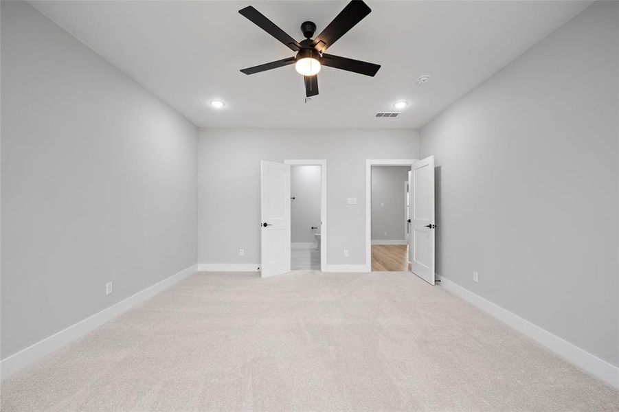 Unfurnished bedroom with recessed lighting, visible vents, light colored carpet, and baseboards