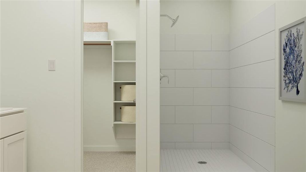 Bathroom featuring vanity and tiled shower