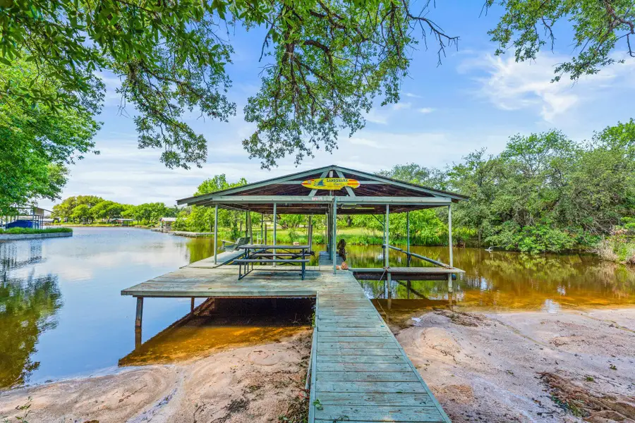 Dual Covered boat dock with a boat ramp and your own private beach