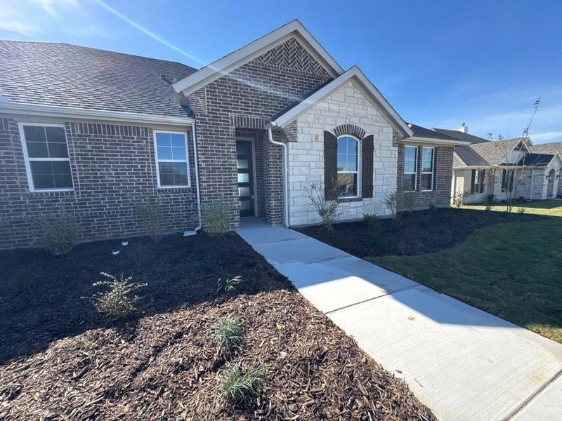Front exterior of a new home in Fairview Meadows, New Fairview, TX, highlighting curb appeal (Image 2).