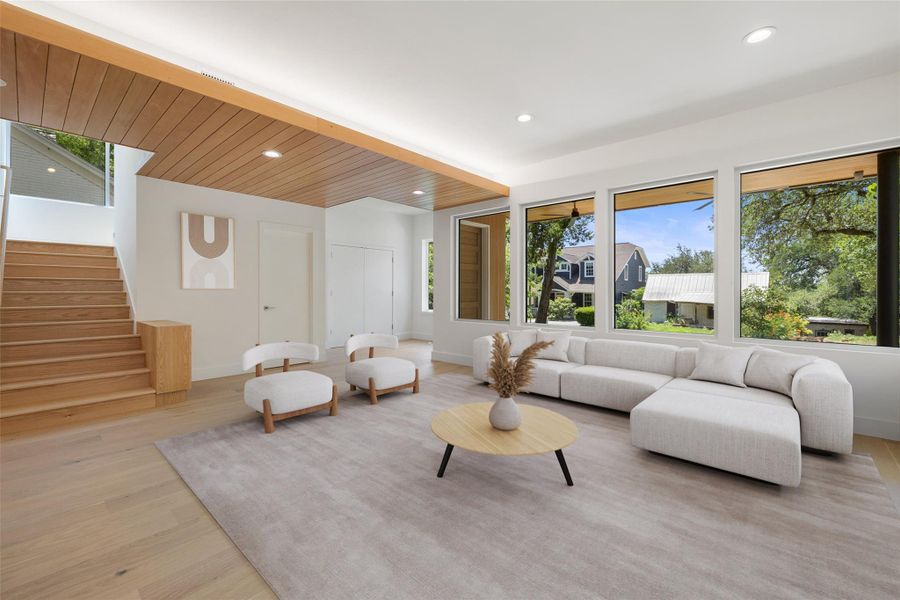 Living room with healthy amount of natural light, recessed lighting, stairs, light wood finished floors, and wood ceiling Living room with healthy amount of natural light, recessed lighting, stairs, light wood finished floors, and wood ceiling