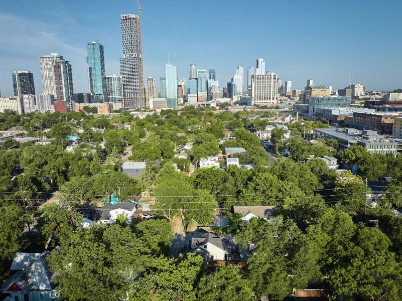 View of city skyline with a tree filled landscape