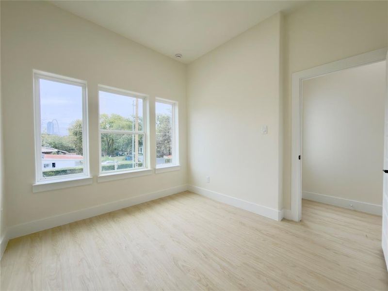 Empty room with light wood-style floors and baseboards