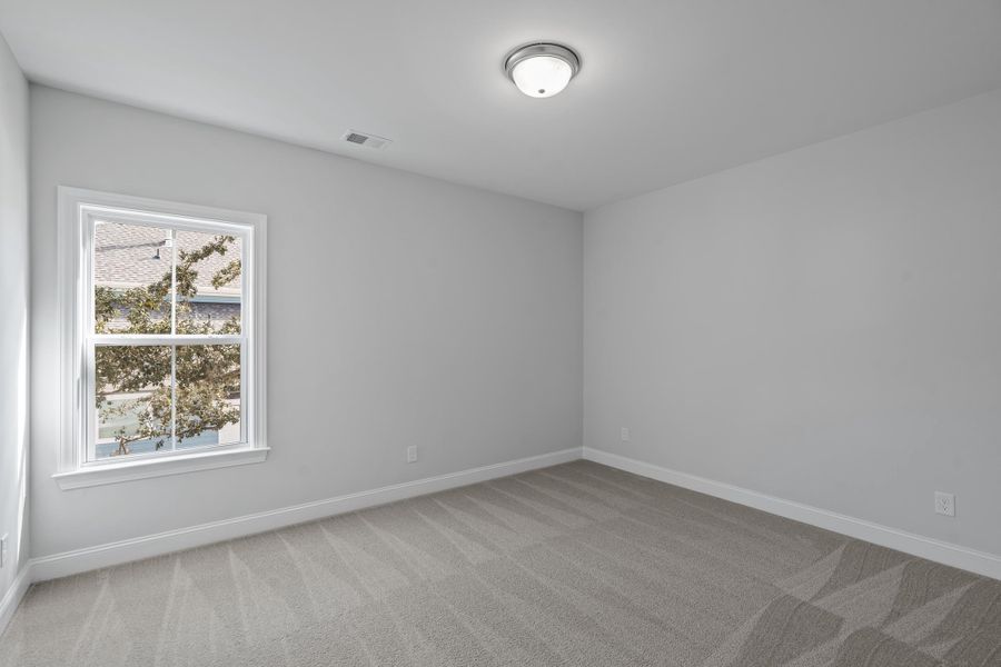 Spacious, unfurnished interior of a new home in K. Hovnanian's® Four Seasons at Lakes of Cane Bay, Summerville (Image 19).