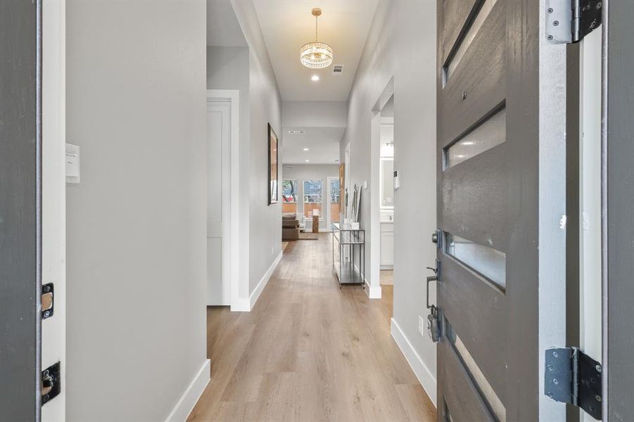 Corridor with light hardwood / wood-style flooring