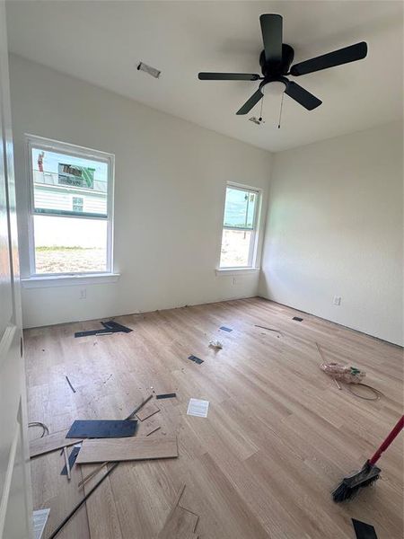 Empty room featuring wood finished floors and ceiling fan Empty room featuring wood finished floors and ceiling fan