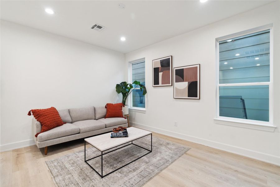 This secondary living area effectively separates the primary and secondary bedrooms, balancing privacy and functionality. It creates distinct living zones while maintaining a cohesive and comfortable environment.