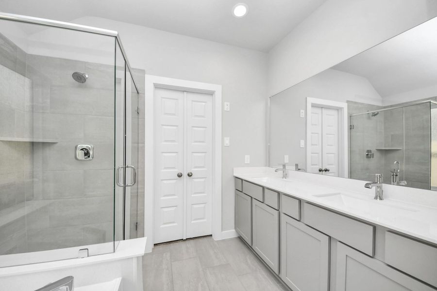 This additional view of the primary bath features a walk-in shower with the tile surround and separate garden tub perfect for soaking after a long day. Sample photo of completed home with similar floor plan. Actual colors and selections may vary. This additional view of the primary bath features a walk-in shower with the tile surround and separate garden tub perfect for soaking after a long day. Sample photo of completed home with similar floor plan. Actual colors and selections may vary.