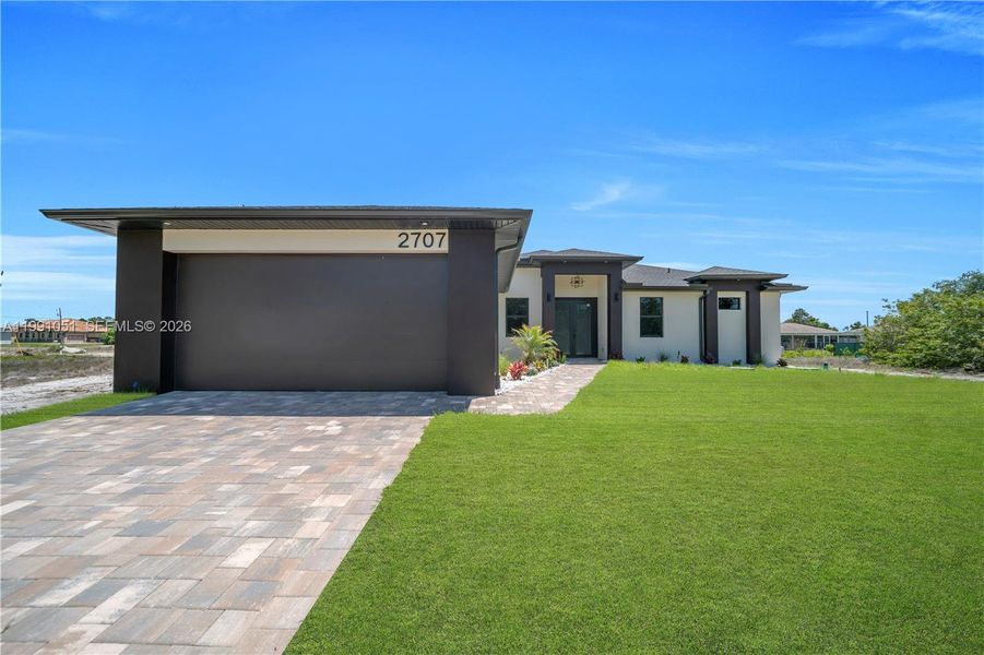 Front exterior of a new home in , Lehigh Acres, FL, highlighting curb appeal (Image 28).