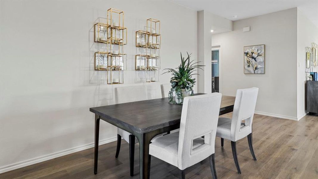 Dining room with wood finished floors and baseboards
