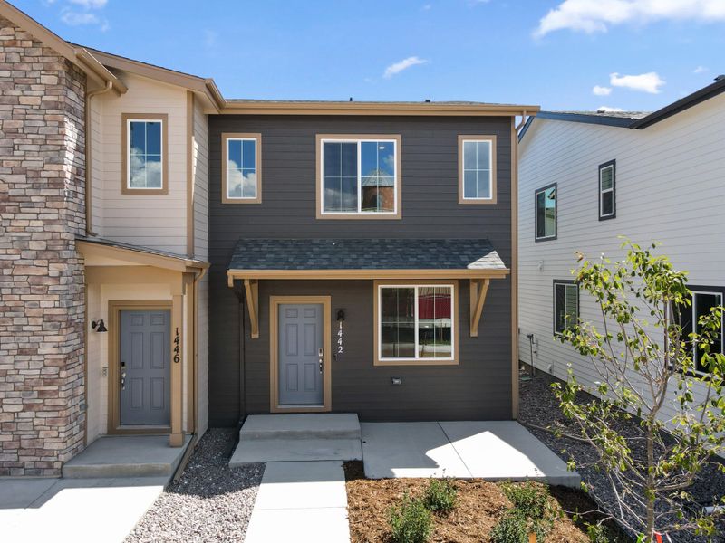 Front exterior of a new home in Spring Valley, Longmont, CO, highlighting curb appeal (Image 1).