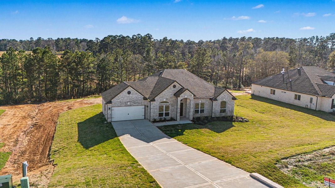 Front exterior of a new home in Rose Hill Estates, Willis, TX, highlighting curb appeal (Image 22).