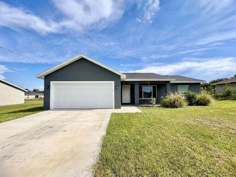 Front exterior of a new home in , Ocklawaha, FL, highlighting curb appeal (Image 1). Front exterior of a new home in , Ocklawaha, FL, highlighting curb appeal (Image 1).