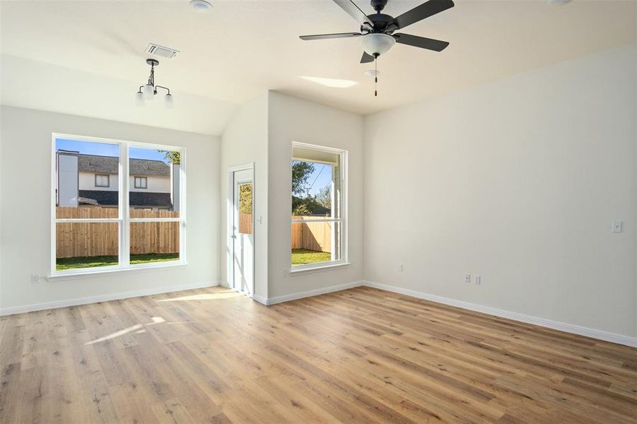 Living room into dining with light wood-style flooring, aand ceiling fan Living room into dining with light wood-style flooring, aand ceiling fan