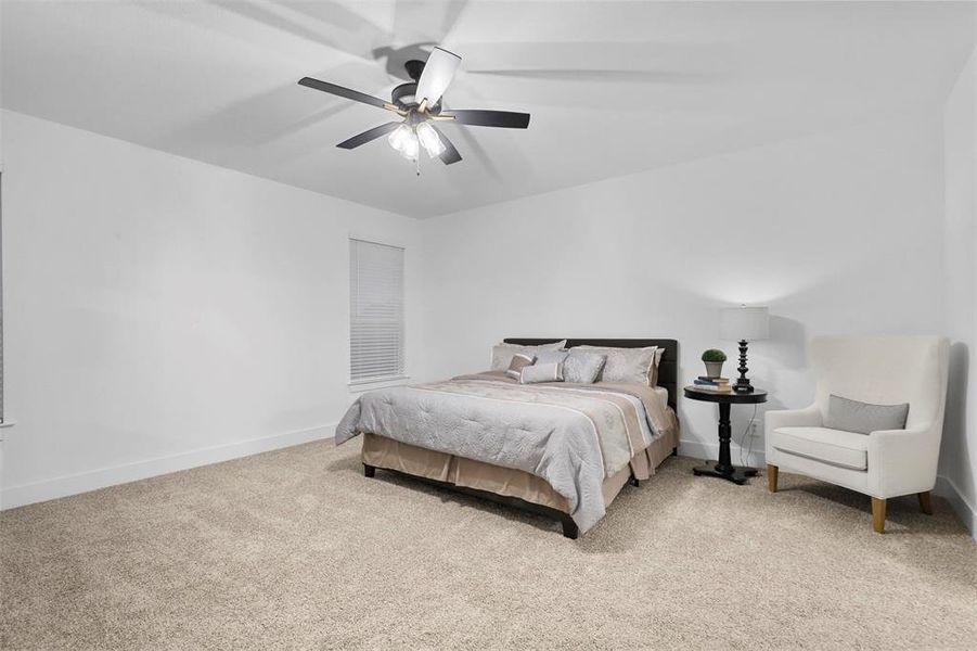 Bedroom featuring ceiling fan and light carpet