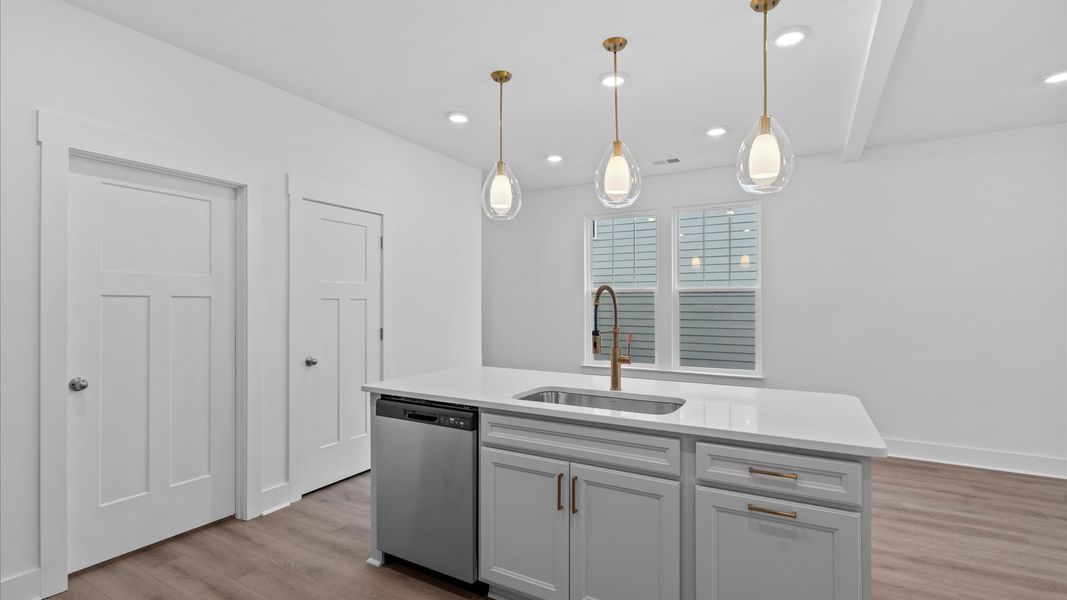 Elegant kitchen with large island and pendant lighting in this first-class DRB Homes design in Moore, SC