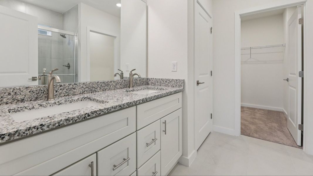 Primary Suite Bath with Dual Sinks in the Naples Floor Plan by DRB Homes Primary Suite Bath with Dual Sinks in the Naples Floor Plan by DRB Homes