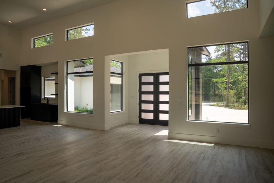 Open floor plan, 17-foot ceilings, large windows for natural light. Thoughtfully designed for comfortable living and entertaining.