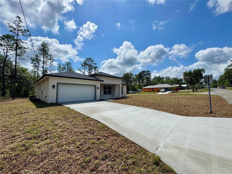 Front exterior of a new home in , Citrus Springs, FL, highlighting curb appeal (Image 1).