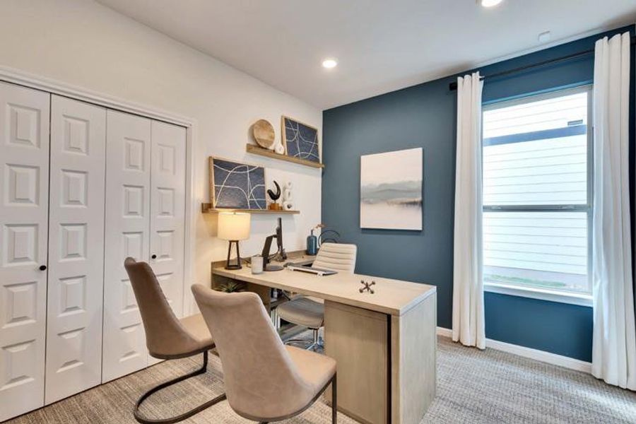 Home office featuring light carpet, recessed lighting, baseboards, and a healthy amount of sunlight