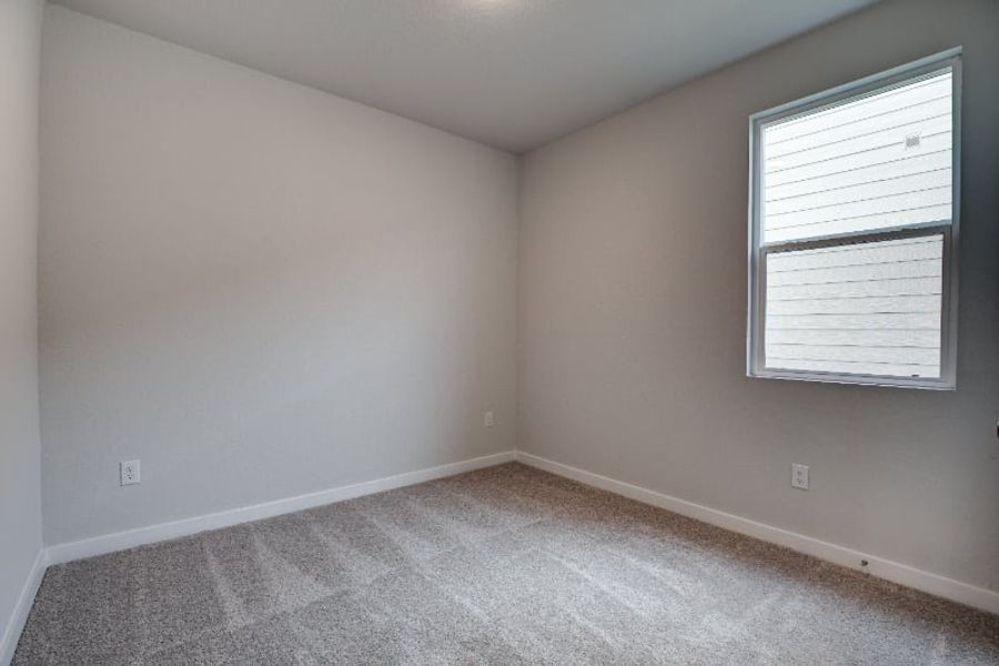 A room with a window and a carpet. A room with a window and a carpet.