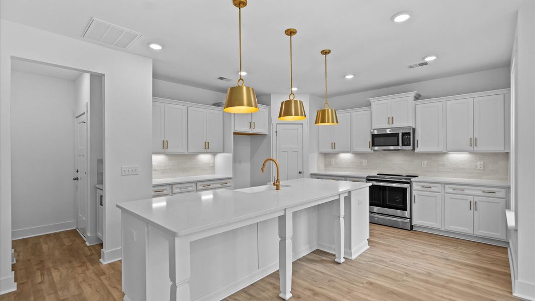 Exceptional culinary space with a striking 10-foot island and eye-catching pendant lights