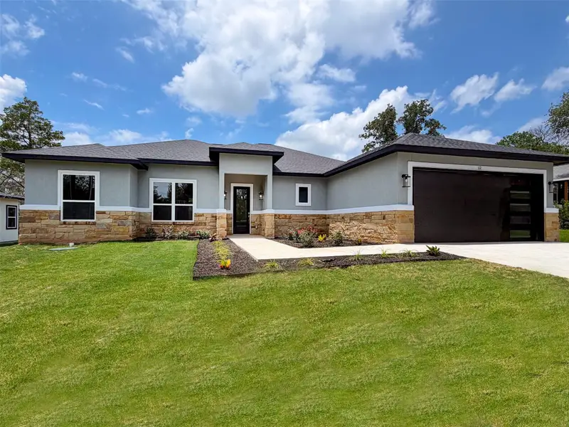 A modern facade with a stone and stucco finish offers exceptional curb appeal and a striking entry. A modern facade with a stone and stucco finish offers exceptional curb appeal and a striking entry.